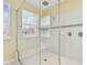 Bright walk-in shower featuring glass surround and bench seating at 4089 Windcrest Dr, Wesley Chapel, FL 33544