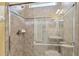 Bathroom showcasing tiled shower with glass door and vanity at 4089 Windcrest Dr, Wesley Chapel, FL 33544