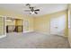 Bedroom featuring French doors, a ceiling fan, and neutral carpet at 4089 Windcrest Dr, Wesley Chapel, FL 33544