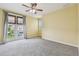 Bedroom featuring French doors, a ceiling fan, and neutral carpet at 4089 Windcrest Dr, Wesley Chapel, FL 33544