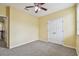 Bedroom featuring double doors and neutral carpet at 4089 Windcrest Dr, Wesley Chapel, FL 33544