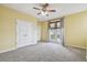 Bedroom featuring French doors to a balcony and neutral carpet at 4089 Windcrest Dr, Wesley Chapel, FL 33544