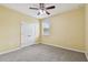 Bedroom featuring bright walls, double-door closet and neutral carpet at 4089 Windcrest Dr, Wesley Chapel, FL 33544