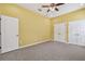 Carpeted bedroom with ceiling fan, two closets, and ample natural light at 4089 Windcrest Dr, Wesley Chapel, FL 33544