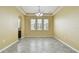 Bright dining room featuring tile flooring, chandelier, and natural light from three windows at 4089 Windcrest Dr, Wesley Chapel, FL 33544