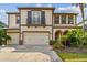 Beautiful two-story home with a three car garage, balcony and meticulously maintained landscaping at 4089 Windcrest Dr, Wesley Chapel, FL 33544