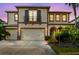 Beautiful two-story home with a three car garage, balcony and meticulously maintained landscaping at 4089 Windcrest Dr, Wesley Chapel, FL 33544