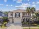 Stunning two-story home with a three-car garage, balcony, and beautifully landscaped front yard at 4089 Windcrest Dr, Wesley Chapel, FL 33544