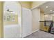 Carpeted hallway with view of the bedroom featuring tray ceilings and many windows at 4089 Windcrest Dr, Wesley Chapel, FL 33544