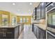 Kitchen showcases a huge island, stainless appliances, granite countertops, and dark wood cabinetry at 4089 Windcrest Dr, Wesley Chapel, FL 33544