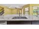 Island sink with modern faucet and granite countertop in a spacious, open-concept kitchen area at 4089 Windcrest Dr, Wesley Chapel, FL 33544