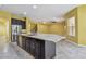 Large kitchen island has granite counters, breakfast bar, and sink with open access to the main living area at 4089 Windcrest Dr, Wesley Chapel, FL 33544