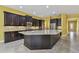 The chef's kitchen features stainless appliances, granite counters, backsplash, and a spacious center island at 4089 Windcrest Dr, Wesley Chapel, FL 33544