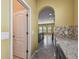 View from kitchen to dining area, showcasing archways, granite countertops and mosaic backslash at 4089 Windcrest Dr, Wesley Chapel, FL 33544
