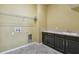 Laundry room with tile flooring, utility sink, storage, and washer/dryer hookups at 4089 Windcrest Dr, Wesley Chapel, FL 33544