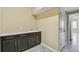 Spacious laundry room featuring storage cabinets, countertop, and utility sink at 4089 Windcrest Dr, Wesley Chapel, FL 33544