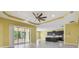 Open floor plan living room flows to the kitchen with access to the lanai for indoor/outdoor entertaining at 4089 Windcrest Dr, Wesley Chapel, FL 33544