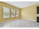 Open living space features tile flooring, natural light from windows, and access to the kitchen area at 4089 Windcrest Dr, Wesley Chapel, FL 33544