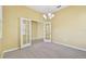Bright office space with glass French doors, neutral carpet, and modern chandelier at 4089 Windcrest Dr, Wesley Chapel, FL 33544
