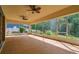 Expansive screened-in patio featuring dual ceiling fans overlooking a beautifully landscaped backyard at 4089 Windcrest Dr, Wesley Chapel, FL 33544