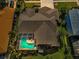 Bird's-eye view of the home showcasing its screened-in pool and well-maintained roof at 4133 Auston Way, Palm Harbor, FL 34685