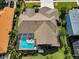 Aerial view of a single Gathering house featuring a screened-in pool and a spacious backyard at 4133 Auston Way, Palm Harbor, FL 34685
