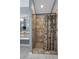 Featuring a tiled shower with palm tree curtain and a vanity in a neutral-toned bathroom at 4133 Auston Way, Palm Harbor, FL 34685