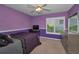 Cozy purple bedroom with white trim, plantation shutters, and a comfortable bed at 4133 Auston Way, Palm Harbor, FL 34685