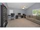Spacious bedroom features neutral colored walls, plush carpeting, ceiling fan and built-in desk with multiple monitors at 4133 Auston Way, Palm Harbor, FL 34685