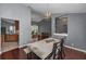 Open floor plan dining area with vaulted ceiling, wood floors and contemporary lighting at 4133 Auston Way, Palm Harbor, FL 34685