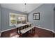 Bright dining room featuring wood floors, elegant furniture, large window, and modern chandelier at 4133 Auston Way, Palm Harbor, FL 34685