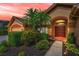Charming front entrance with double doors, mature landscaping, and inviting walkway at 4133 Auston Way, Palm Harbor, FL 34685