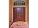 Inviting, elegant double front door with transom window, brick flooring and funny doormat at 4133 Auston Way, Palm Harbor, FL 34685