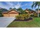 Beautiful single-Gathering home with a three-car garage and meticulously landscaped front yard at 4133 Auston Way, Palm Harbor, FL 34685