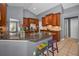 Kitchen with granite countertops, wood cabinets, and tile flooring at 4133 Auston Way, Palm Harbor, FL 34685