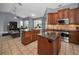 Open kitchen with stainless appliances, granite countertops, tile floors, and a seamless flow to the living area at 4133 Auston Way, Palm Harbor, FL 34685