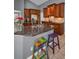 Kitchen with granite countertops, wood cabinets and breakfast bar seating at 4133 Auston Way, Palm Harbor, FL 34685