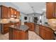 Spacious kitchen showcasing ample countertop space, stainless appliances, and an island at 4133 Auston Way, Palm Harbor, FL 34685