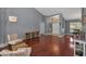 Spacious living room with hardwood floors, neutral paint, and views to the dining room at 4133 Auston Way, Palm Harbor, FL 34685