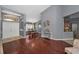 Open concept living and dining areas with hardwood floors and a view of the kitchen at 4133 Auston Way, Palm Harbor, FL 34685