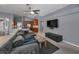 Open-concept living room featuring gray walls, cozy seating, and view of the modern kitchen at 4133 Auston Way, Palm Harbor, FL 34685
