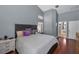 Spacious main bedroom with gray walls, hardwood floors, and ensuite bathroom access at 4133 Auston Way, Palm Harbor, FL 34685