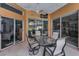Covered patio area with a dining table with chairs, overhead fan and view of yard at 4133 Auston Way, Palm Harbor, FL 34685
