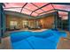 Relaxing backyard pool with screened enclosure and ample seating at 4133 Auston Way, Palm Harbor, FL 34685