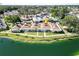 An aerial view of a waterfront townhome featuring a lush green lawn and scenic water views at 4324 Tahitian Gardens Cir # J, Holiday, FL 34691