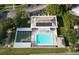 Aerial view of a community pool with shuffleboard courts and ample parking at 4324 Tahitian Gardens Cir # J, Holiday, FL 34691