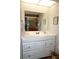 Bright bathroom features a vanity with white cabinets and a large mirror at 4324 Tahitian Gardens Cir # J, Holiday, FL 34691