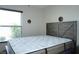 Bedroom showcases a large window offering natural light, and a stylish headboard at 4324 Tahitian Gardens Cir # J, Holiday, FL 34691