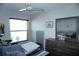 Bedroom with ceiling fan and a window for natural light at 4324 Tahitian Gardens Cir # J, Holiday, FL 34691