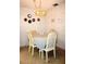 Cozy dining area with a chandelier and table set for four, accented with decorative wall plates at 4324 Tahitian Gardens Cir # J, Holiday, FL 34691
